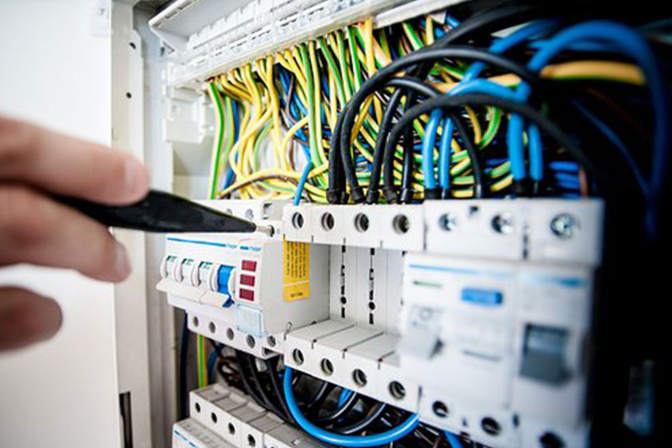 an electrician is checking the electric panel