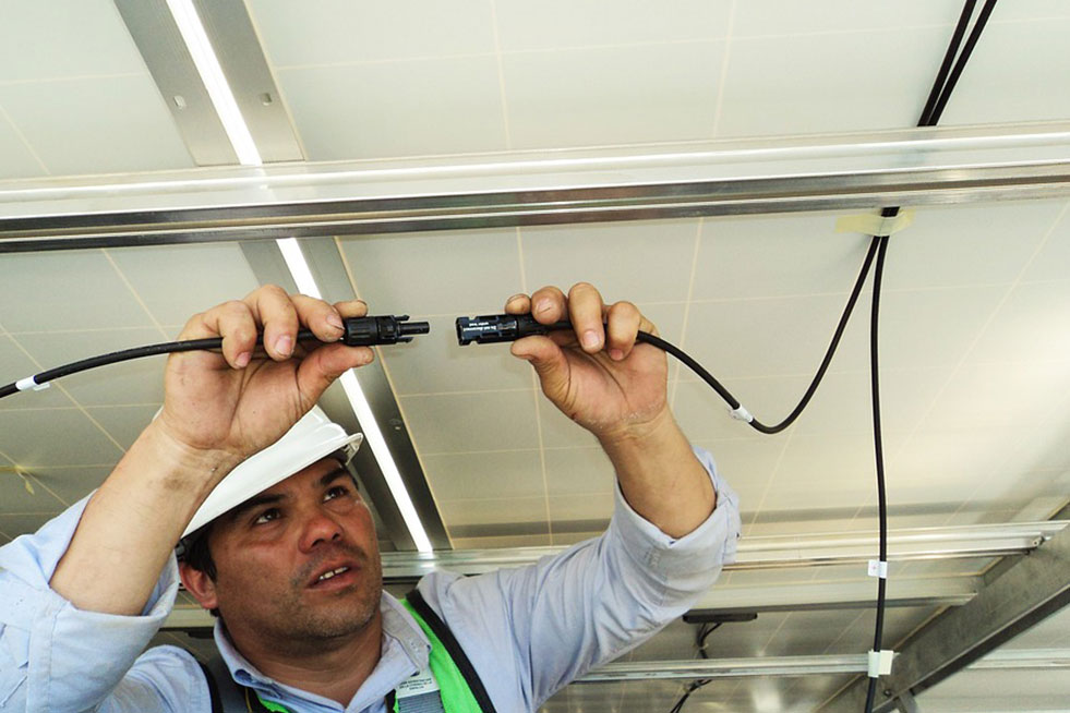 an electrician is connecting the cables